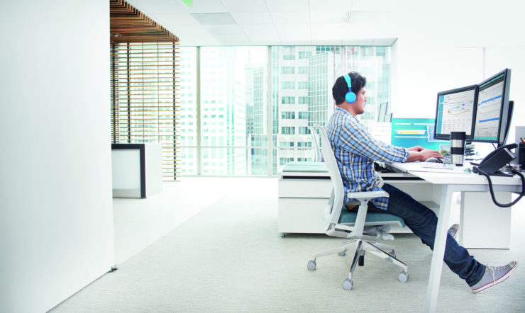 Guy working at desk with Microsoft Azure