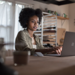 Female working on project using Microsoft Surface Laptop (platinum) in a ceramic workshop