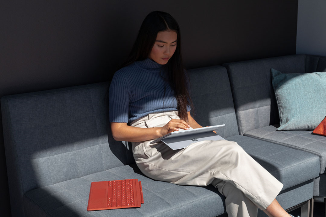 Contextual image of woman inside working on Surface Pro 7