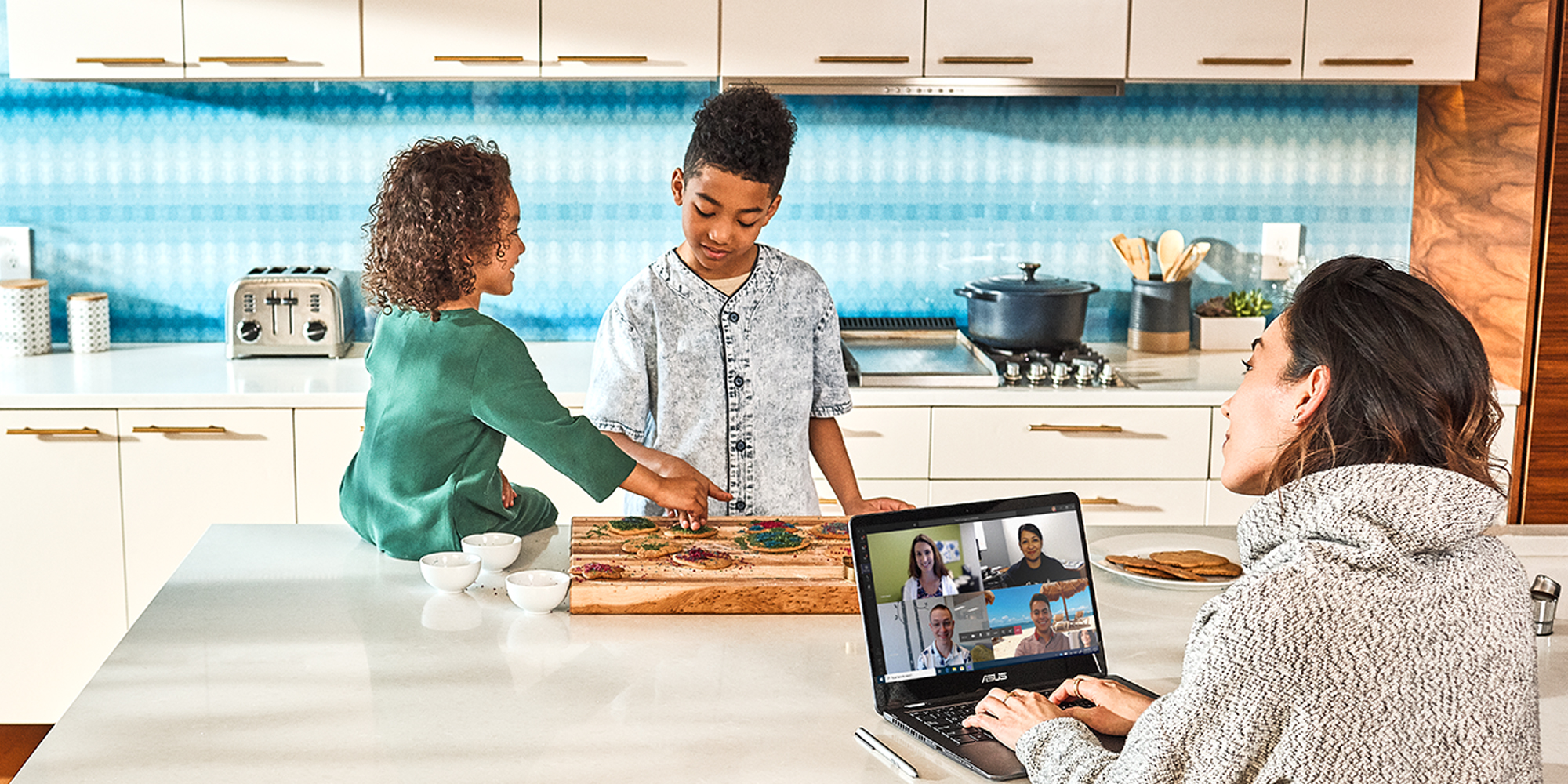 a group of people sitting at a table with a laptop