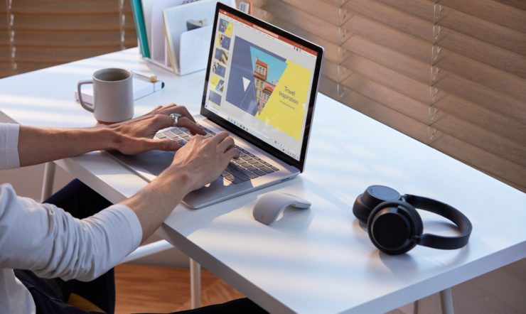 a person sitting at a desk in front of a computer