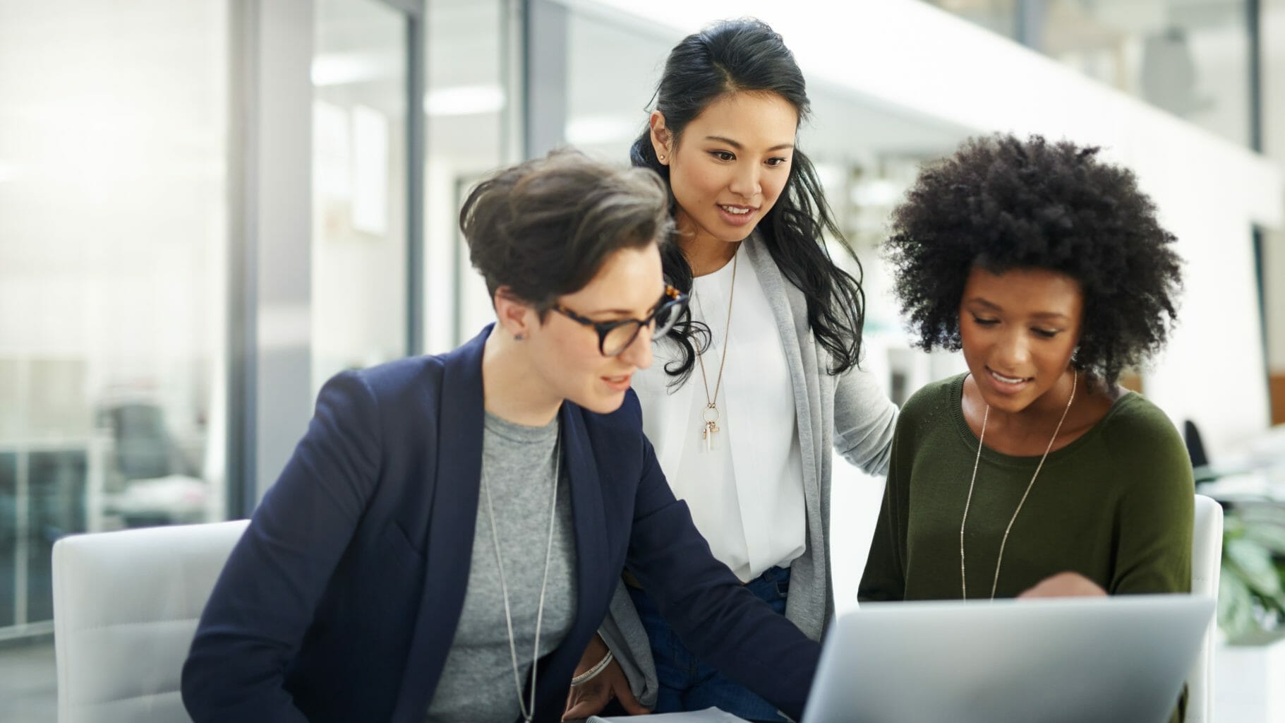 three women watching a computer