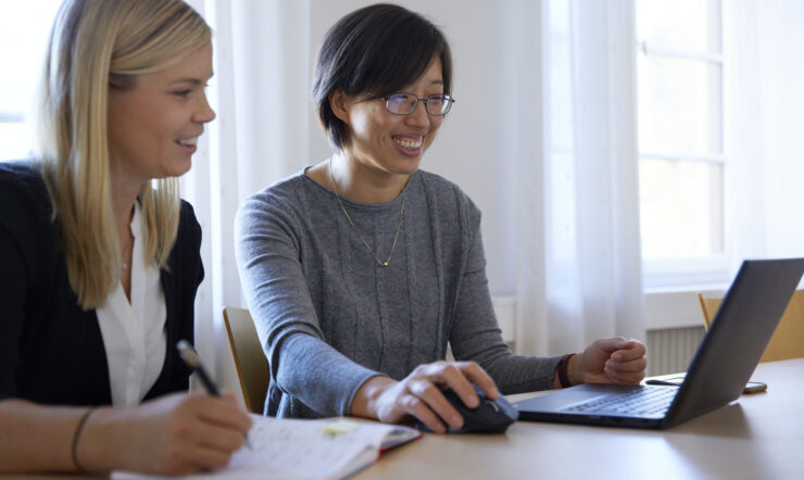 Two women in an office looking at a computer